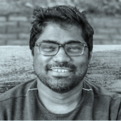 A front facing profile photo of Akash who is smiling.